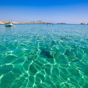 crystal clear waters on the beach of Lindos, Rhodes Island, Dodecanese, Greece.